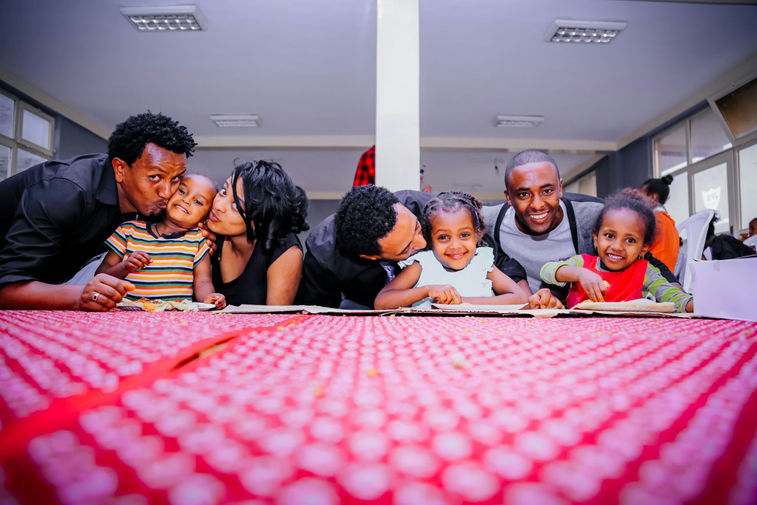 Young children eat at table with adults